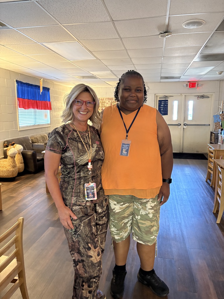 people smiling at the camera wearing camo