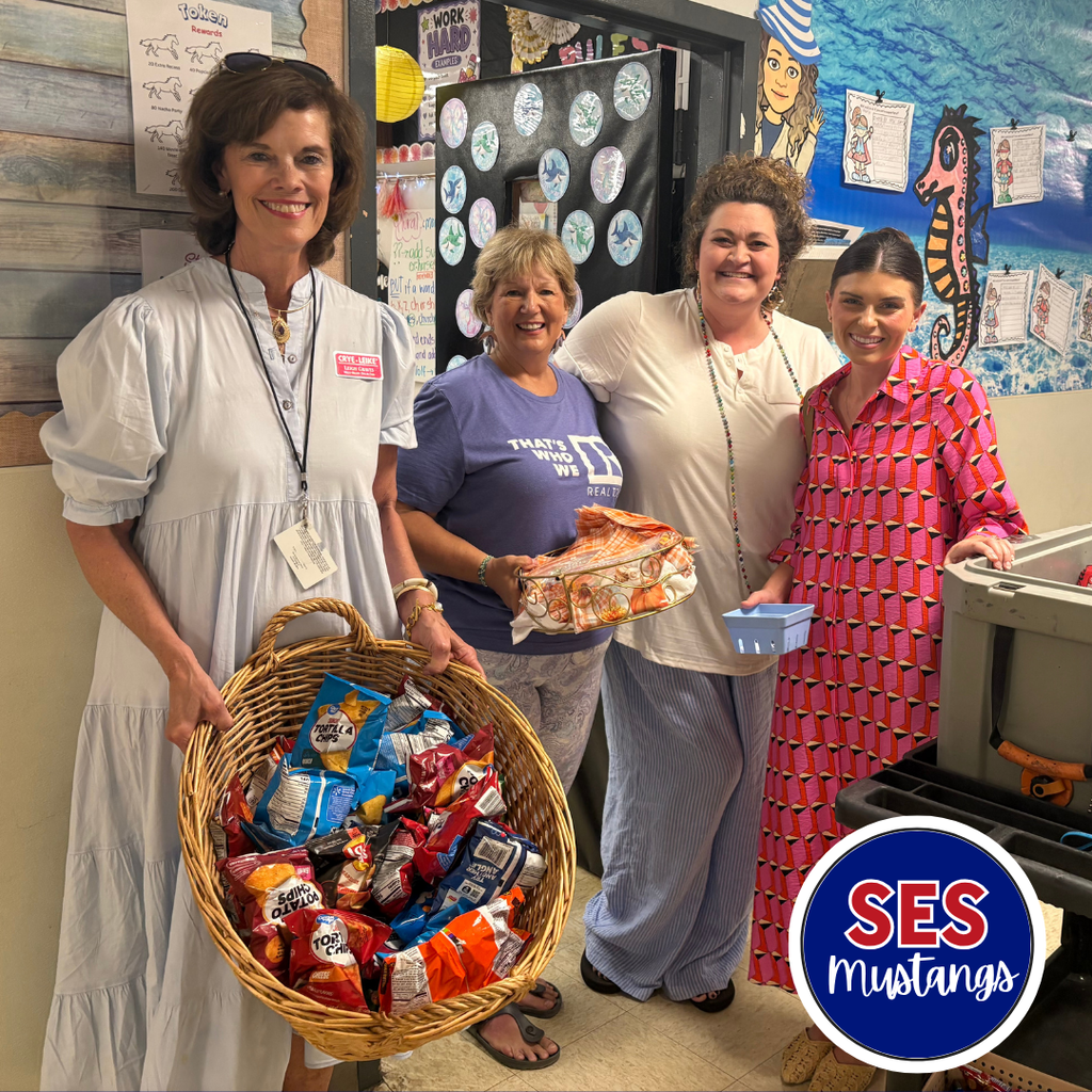 teachers smiling at camera holding snacks