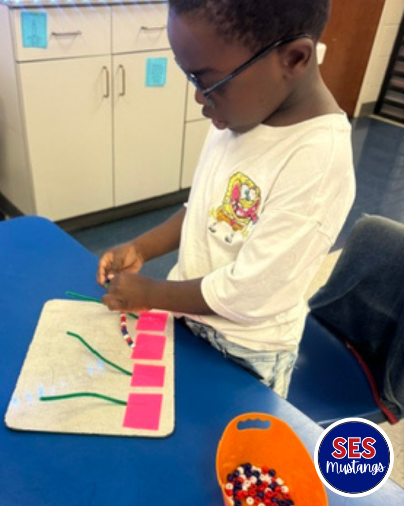 student with beads