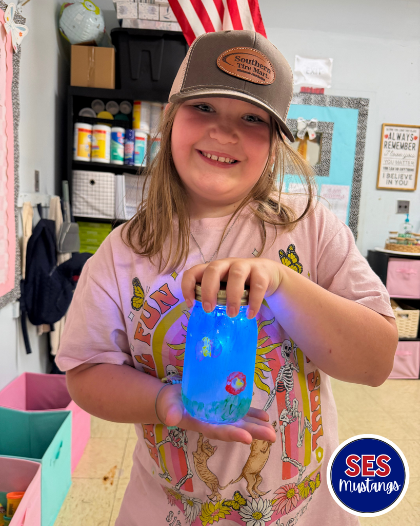girl holding a jar