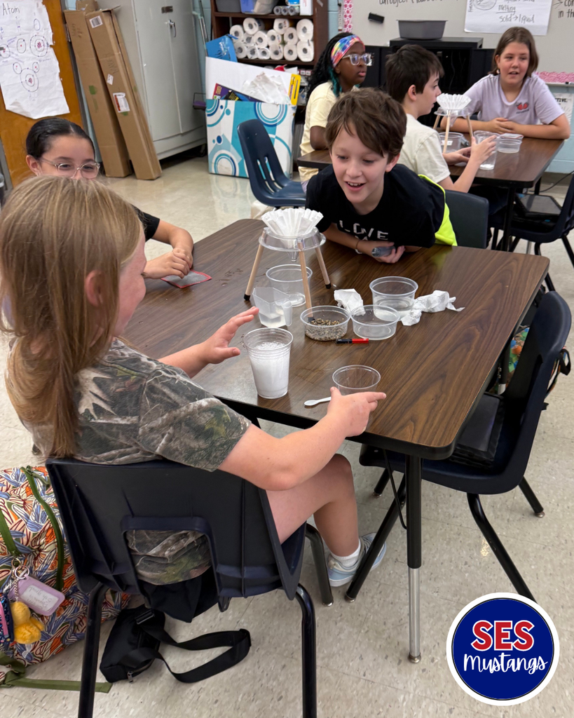 students working in groups with science equipment