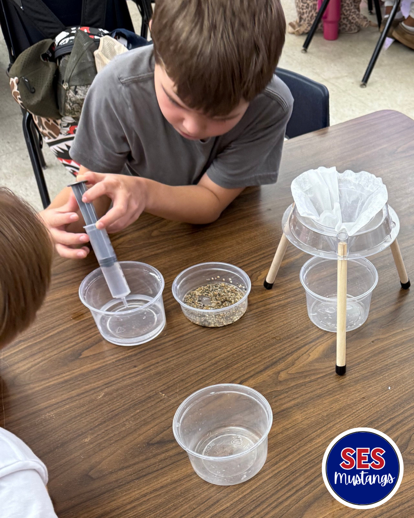 students working in groups with science equipment