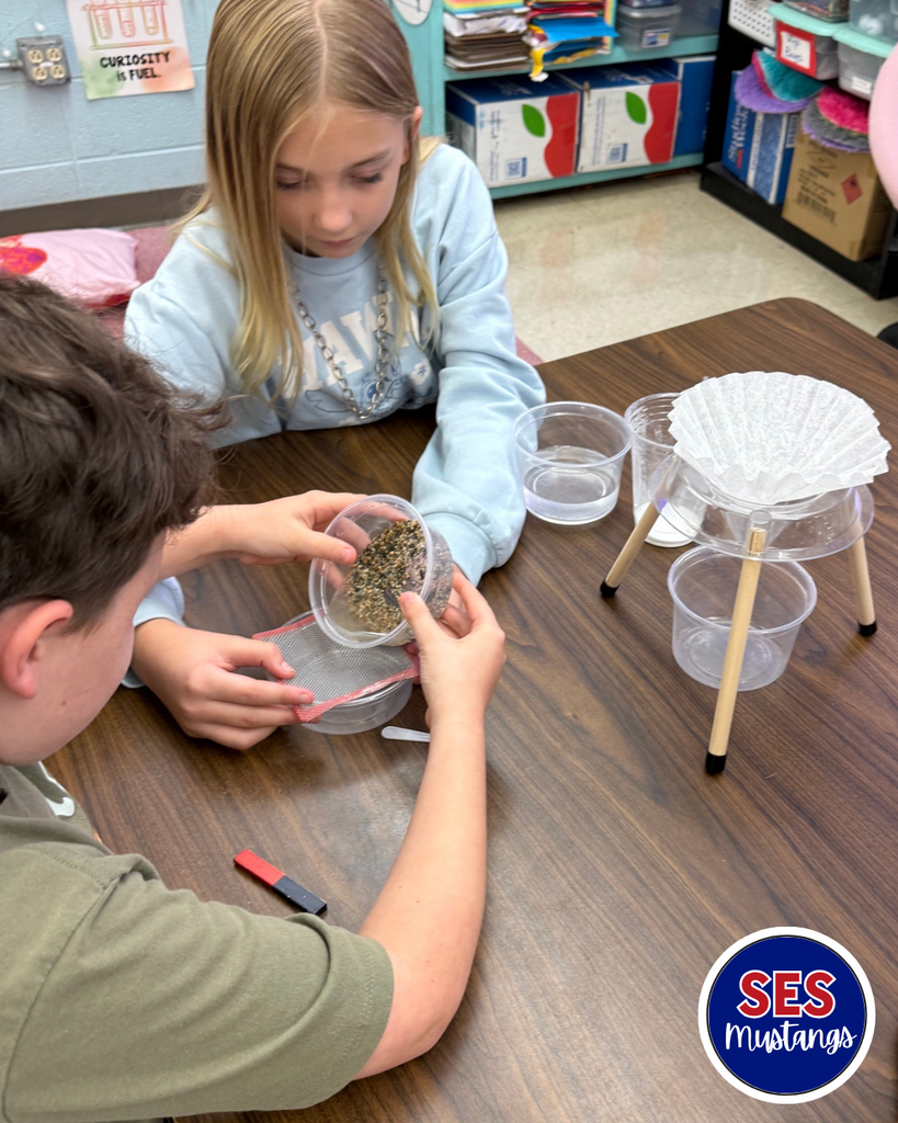 students working in groups with science equipment