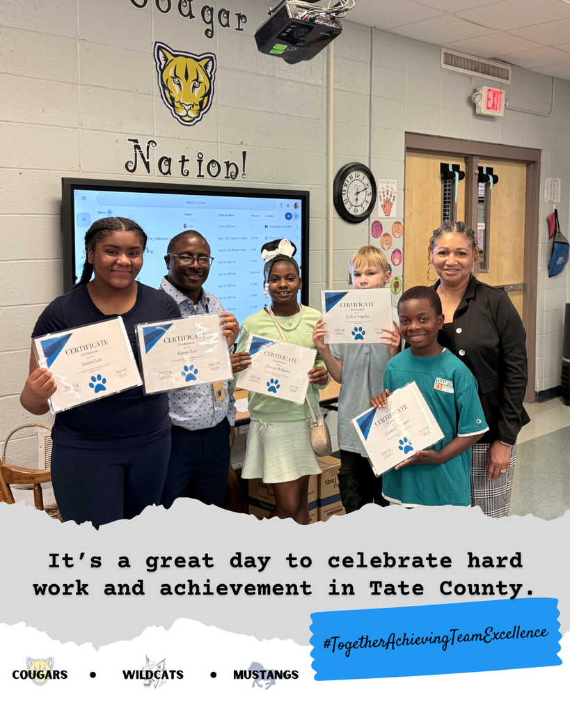 Student smiling with certificates.
