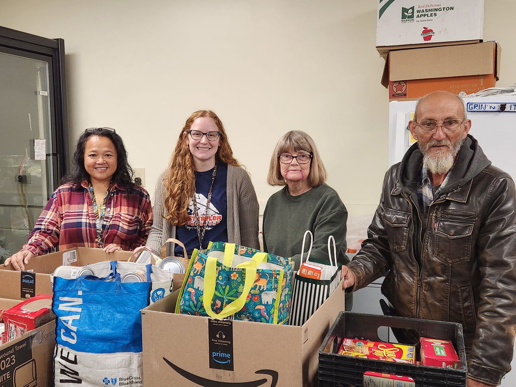 Taylor County Schools representatives providing donated food to local food banks