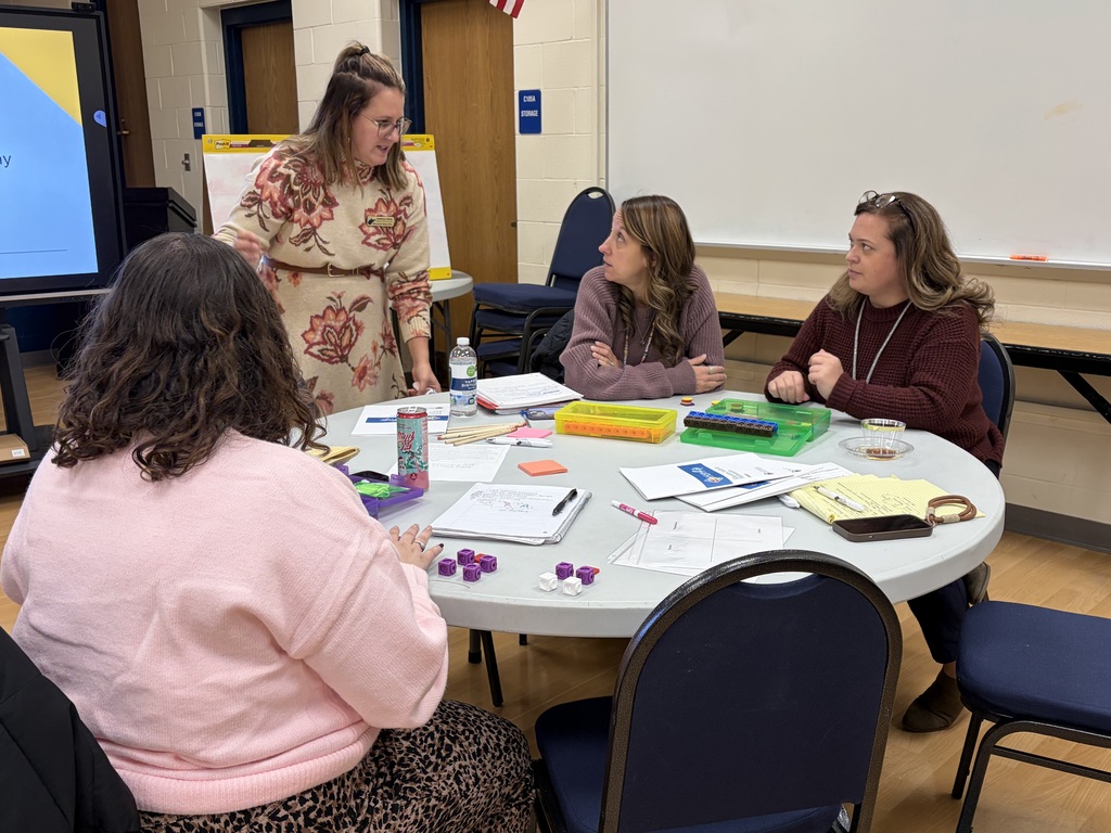 3 teachers listening to the presenter share information