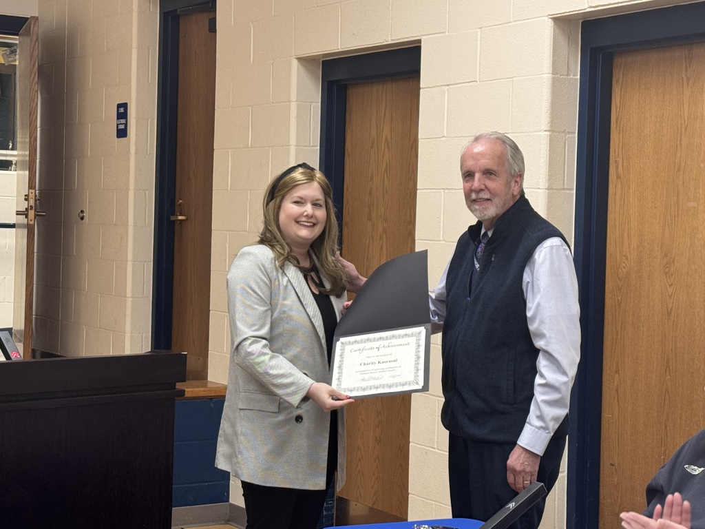 Charity Kasraoui receives certificate from Dr. John Stallings