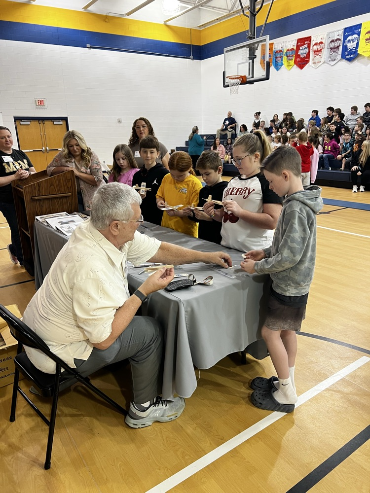 Ed Waske with students making model airplanes