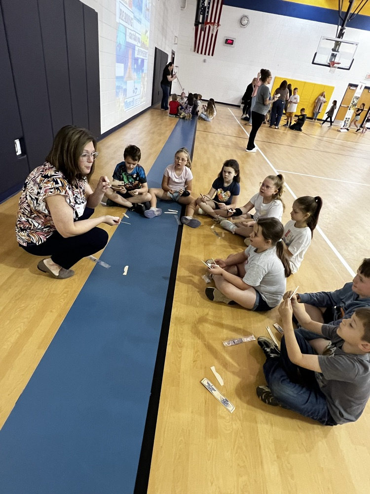 Katie Westfall with students making model airplanes