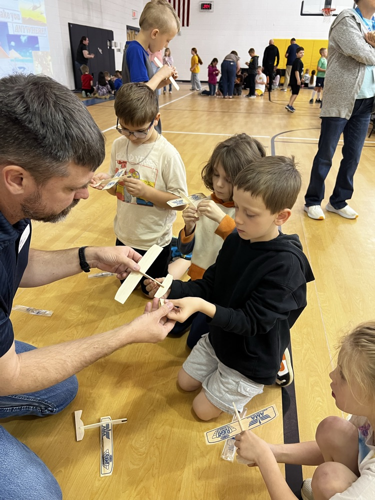 John Murray with students making airplanes