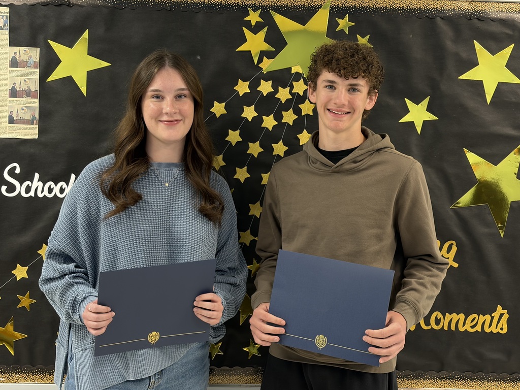 2 students holding certificates