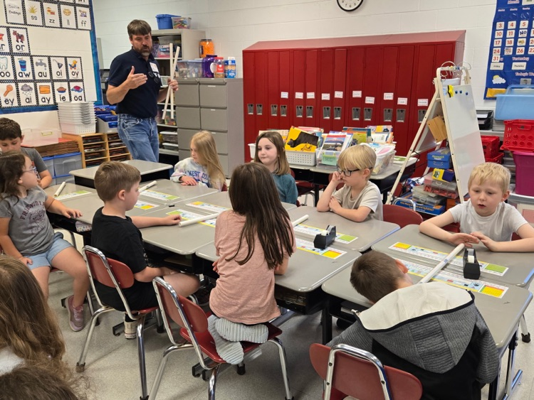 John Murray teaching the kids how to make their rockets.
