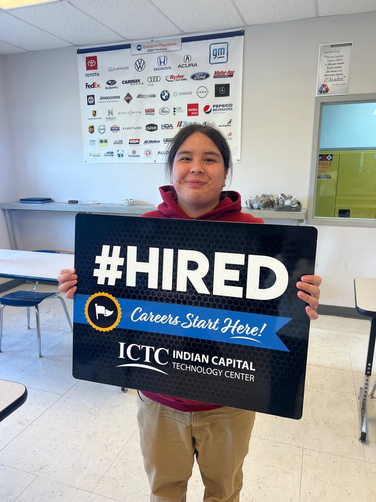 Person holding up a sign that reads "#HIRED Careers Start Here! ICTC INDIAN CAPITAL TECHNOLOGY CENTER".