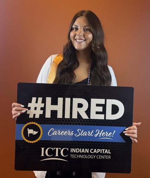 Woman holding a sign saying "#HIRED" and "Careers Start Here!" with ICTC logo. She smiles.