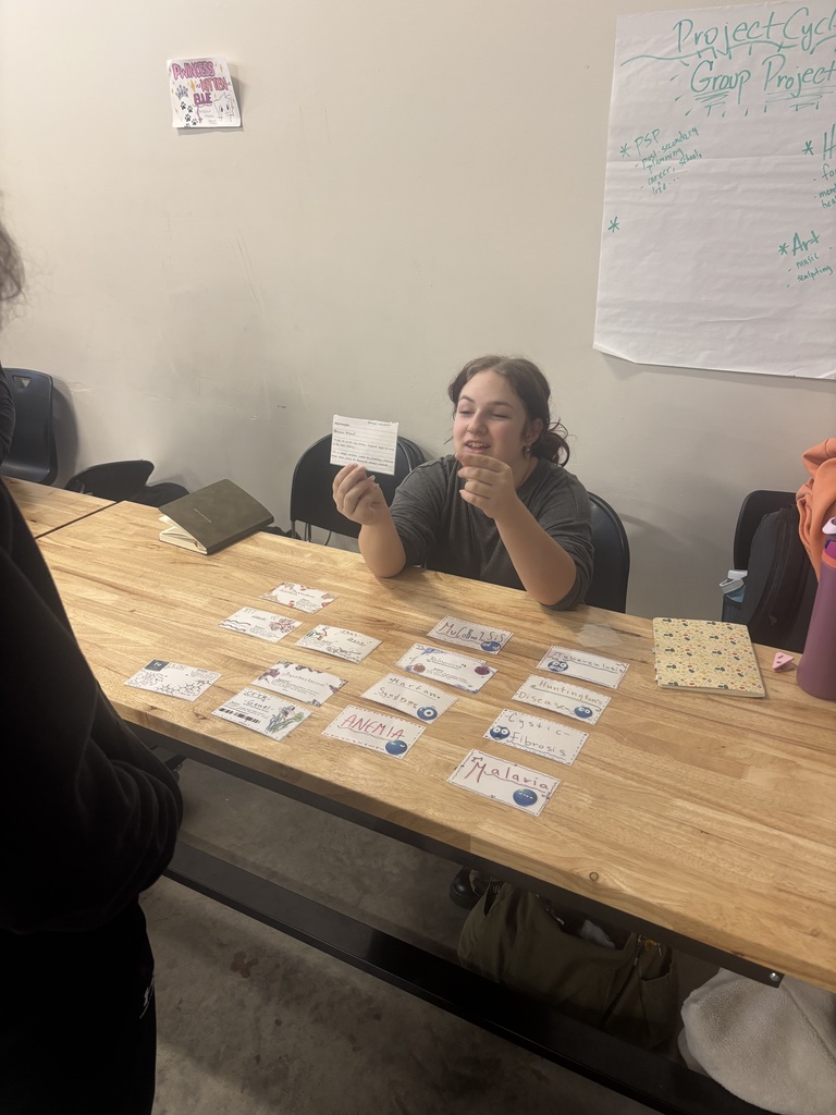 Student holds up flash cards they made