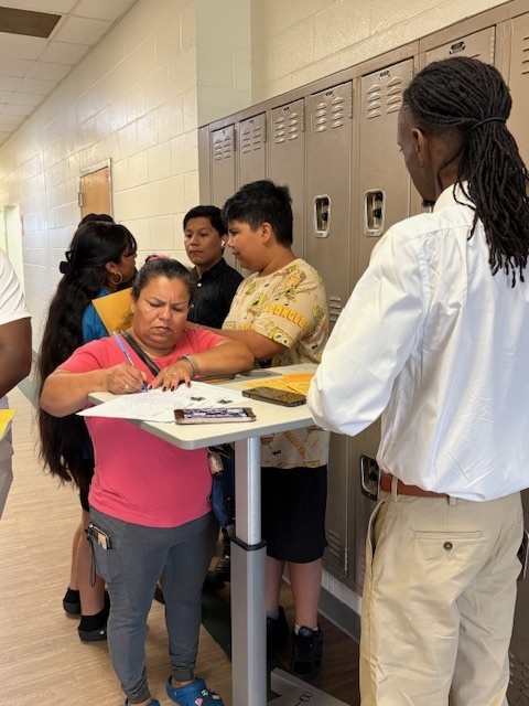 A family meeting a teacher at Open House
