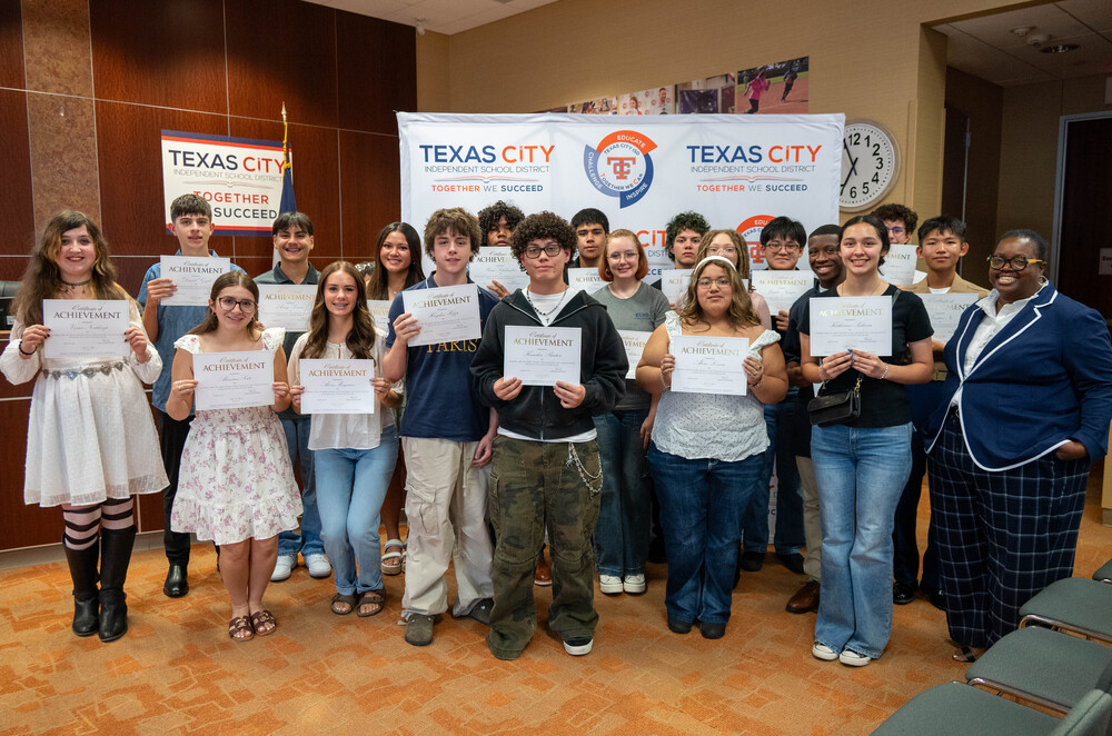 Group photo of 19 high school students earning College Board honors with school board president