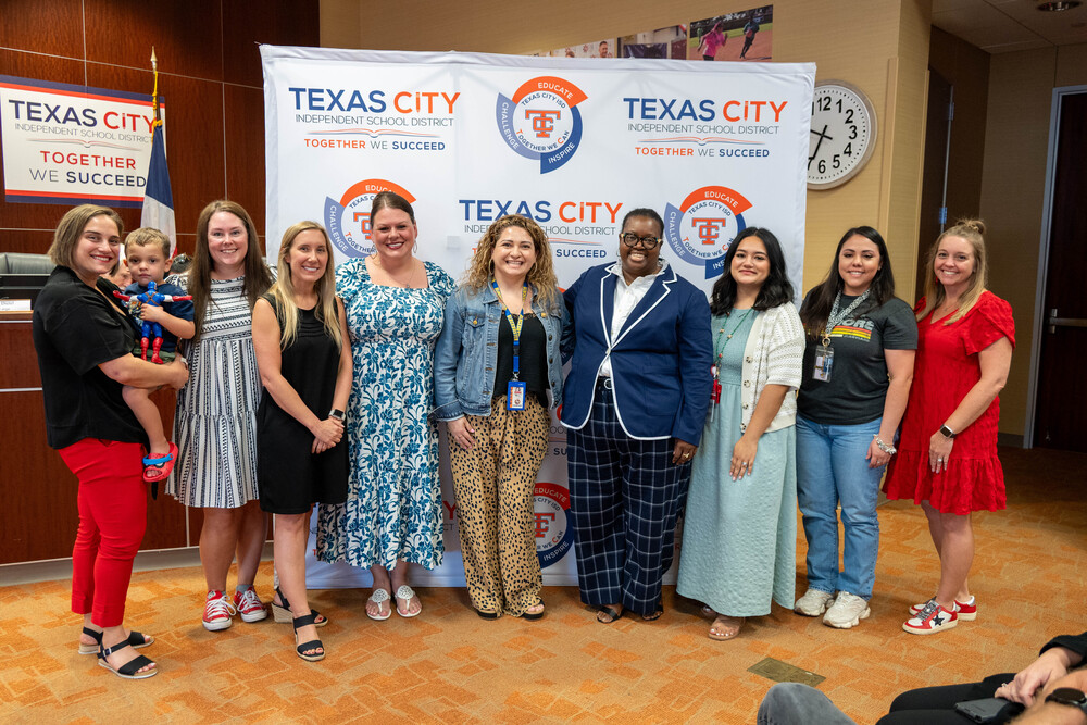Group photo of Heights Elementary educators with the board president