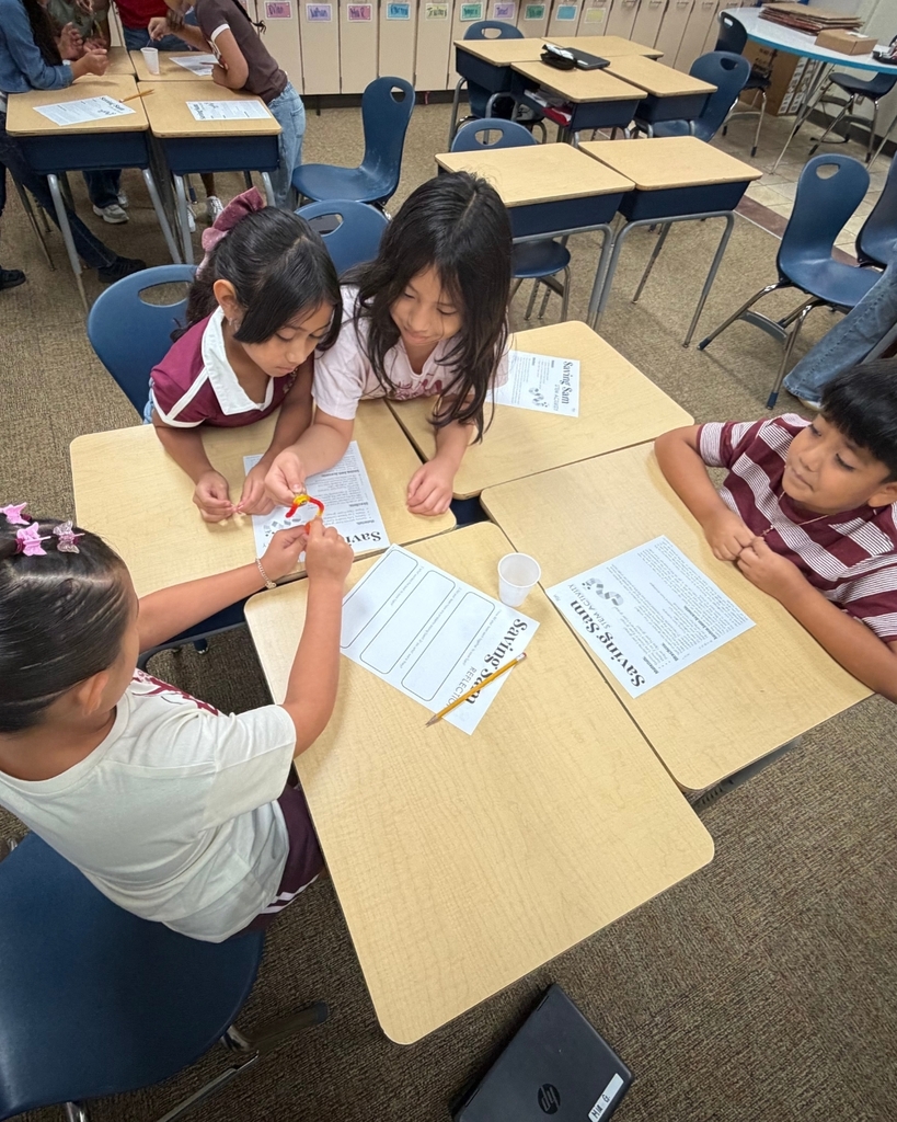 Students work together at their desks during the Saving Sam STEM activity.