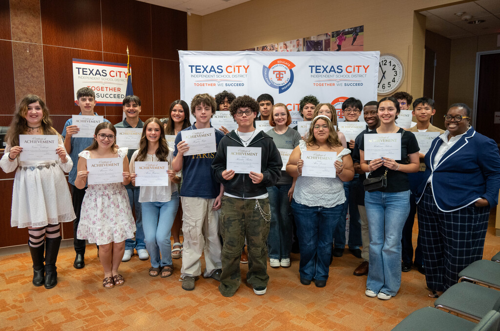TCHS and LMHS students pose with certificates in front of a TCISD backdrop.