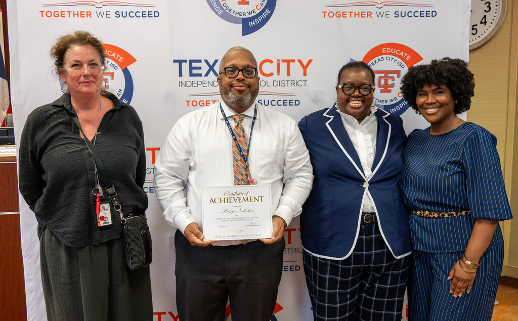 La Marque High School Principal Ricky Nicholson receives a certificate from Board President Nakisha Paul.