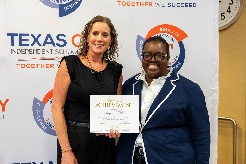 Blocker Middle School Principal Megan Willis receives a certificate from Board President Nakisha Paul.