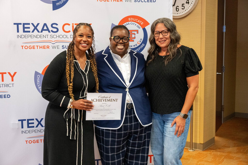 Roosevelt-Wilson Elementary receives a certificate from Board President Nakisha Paul.