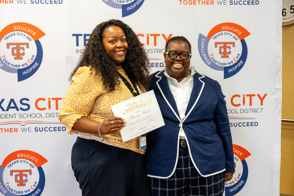 Giles Middle School Principal Kanestra Bland receives a certificate from Board President Nakisha Paul.