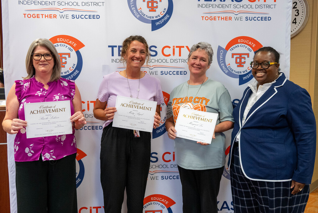 TCISD Business Office team members pose with certificates alongside Board President Nakisha Paul.