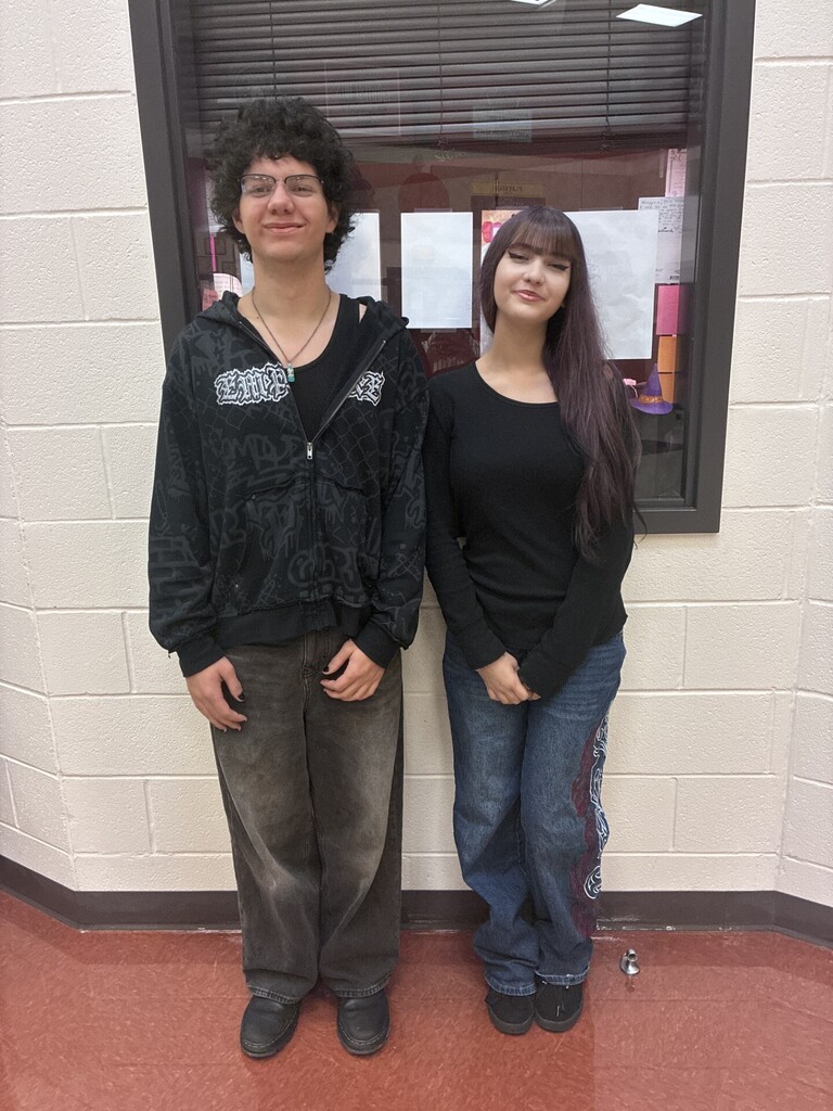 Two choir students pose together smiling