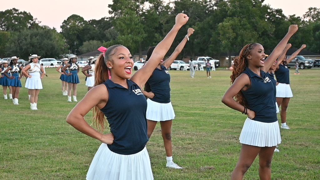 Members of the cheerleading squad cheer during the Homecoming Pep Rally.