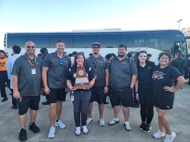 Band staff and the fine arts director with their Division 1 trophy