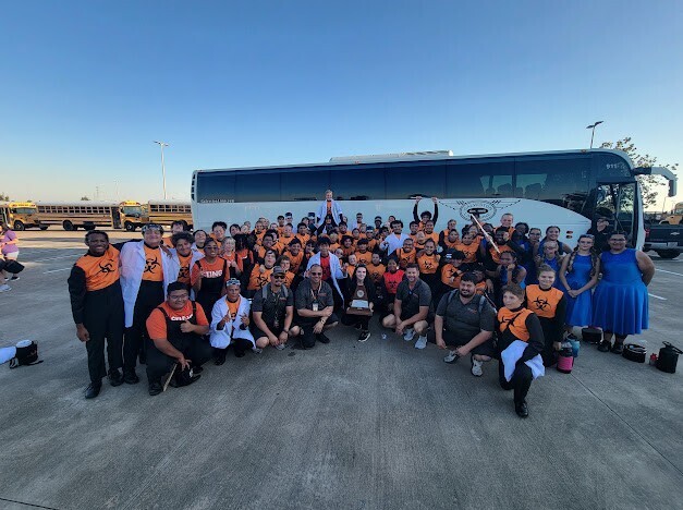 The entire marching band, color guard and directors with their trophy