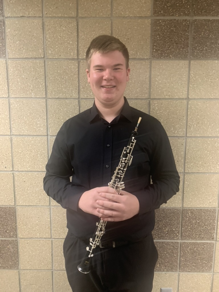 Here's Cooper with his oboe dressed in professional black attire.