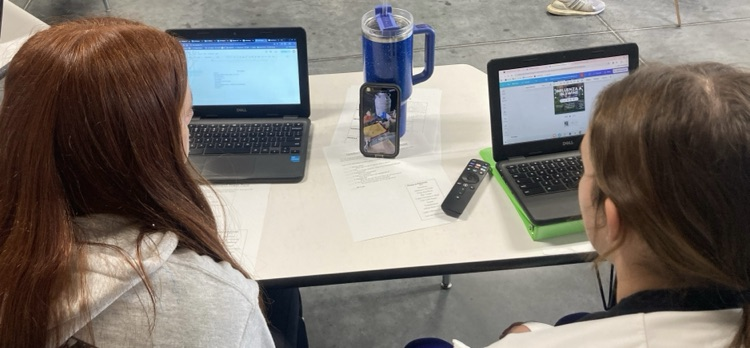 Emily and Laikynn watching how the embryos are put in the surrogate cows. 