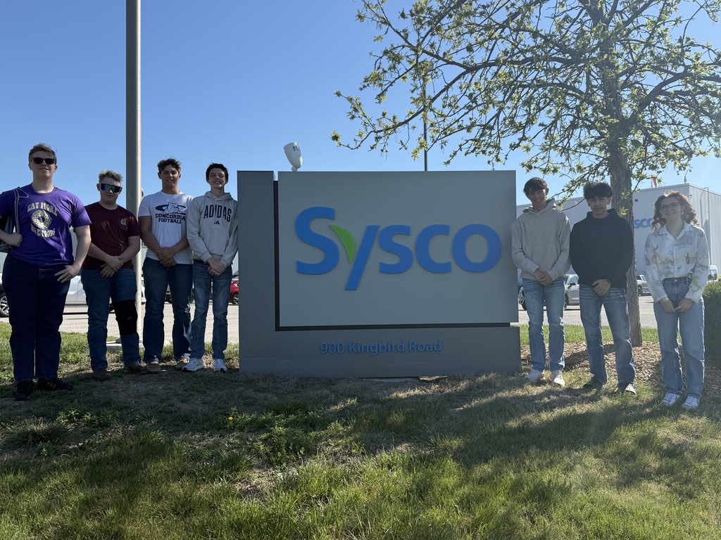 students in front of the Sysco sign