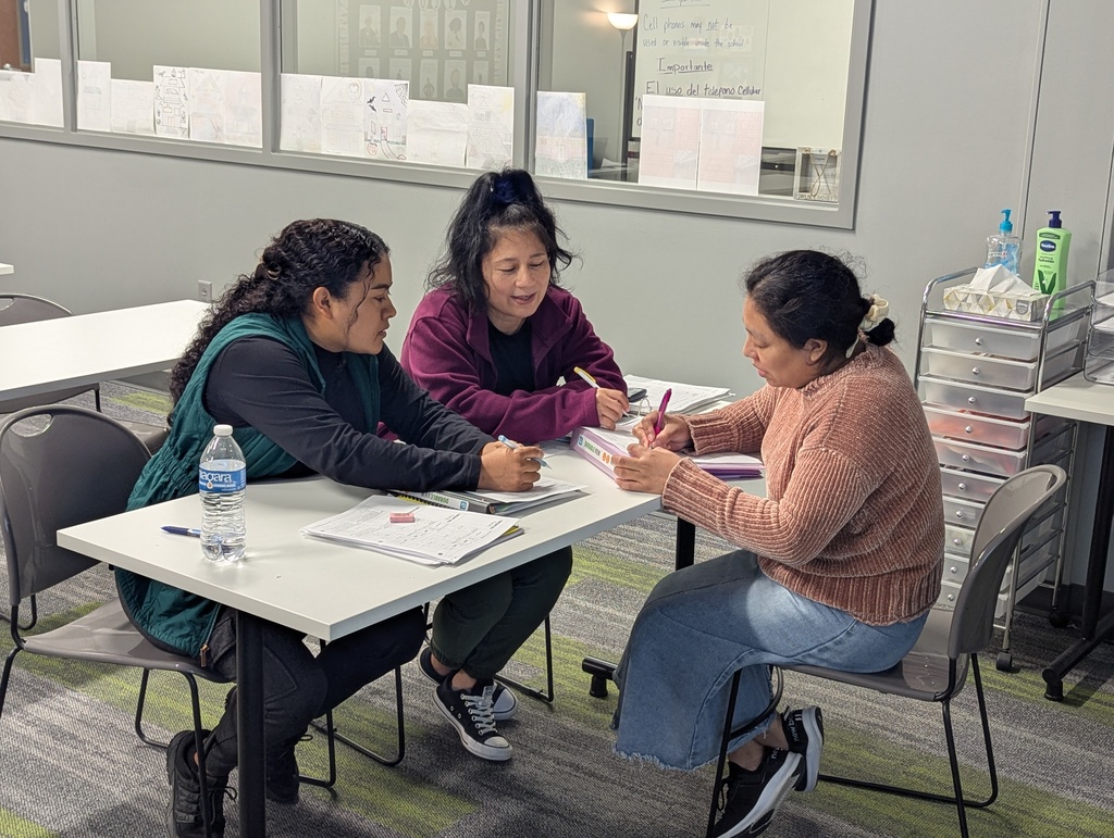 Photo of students working together in class