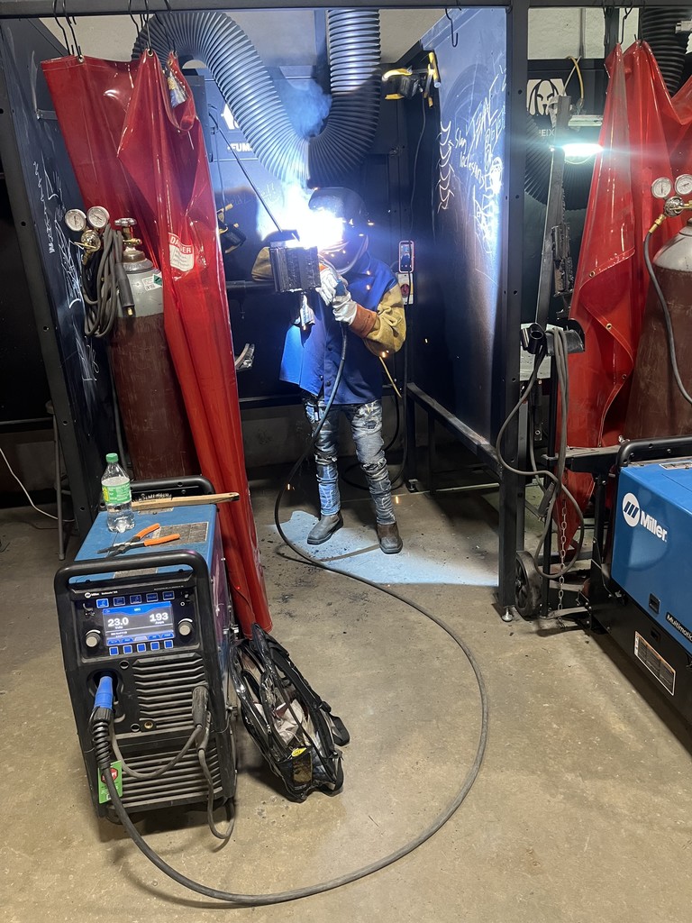 Student working in designated welding area. 