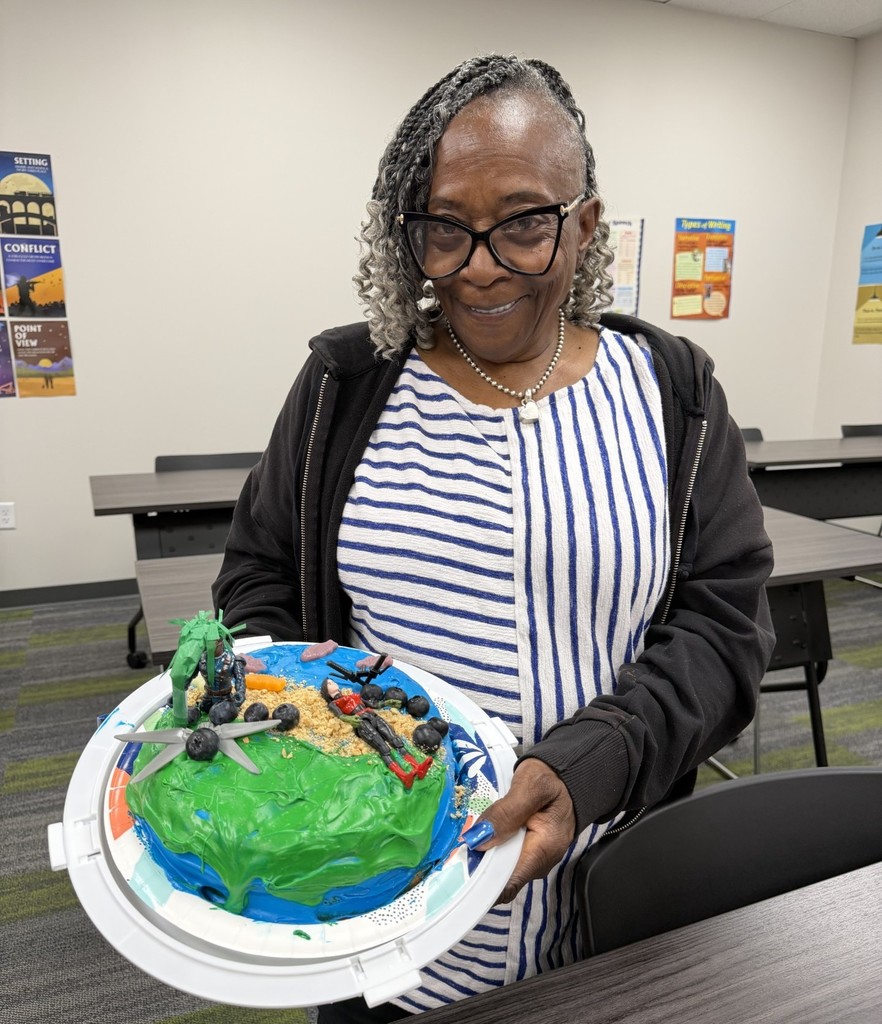 student holding a cake she made