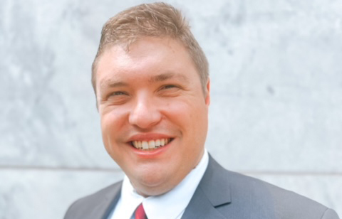 man in blue suit smiling