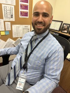 principal smiling at his desk