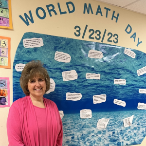 teacher in front of classroom board