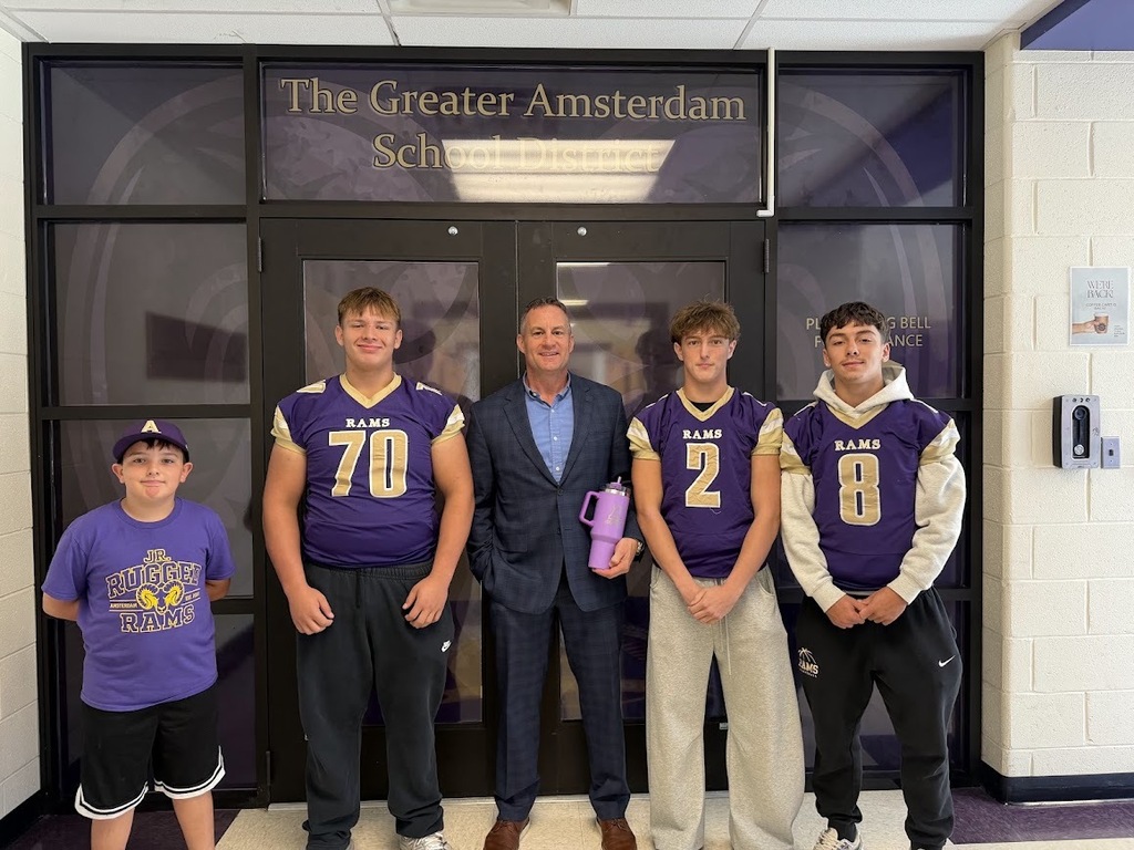 three football players and superintendent 