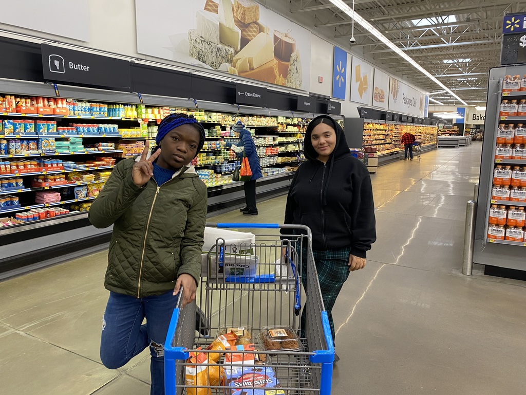 two students with grocery cart