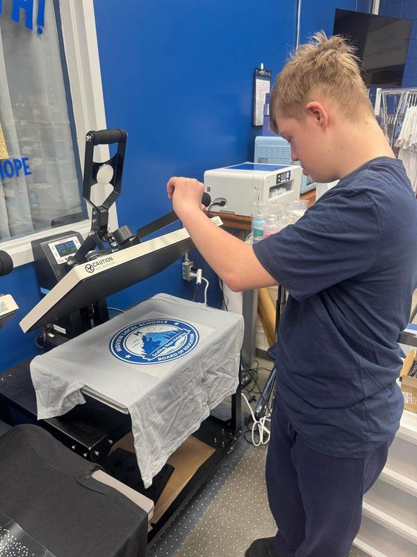 Student pressing shirts