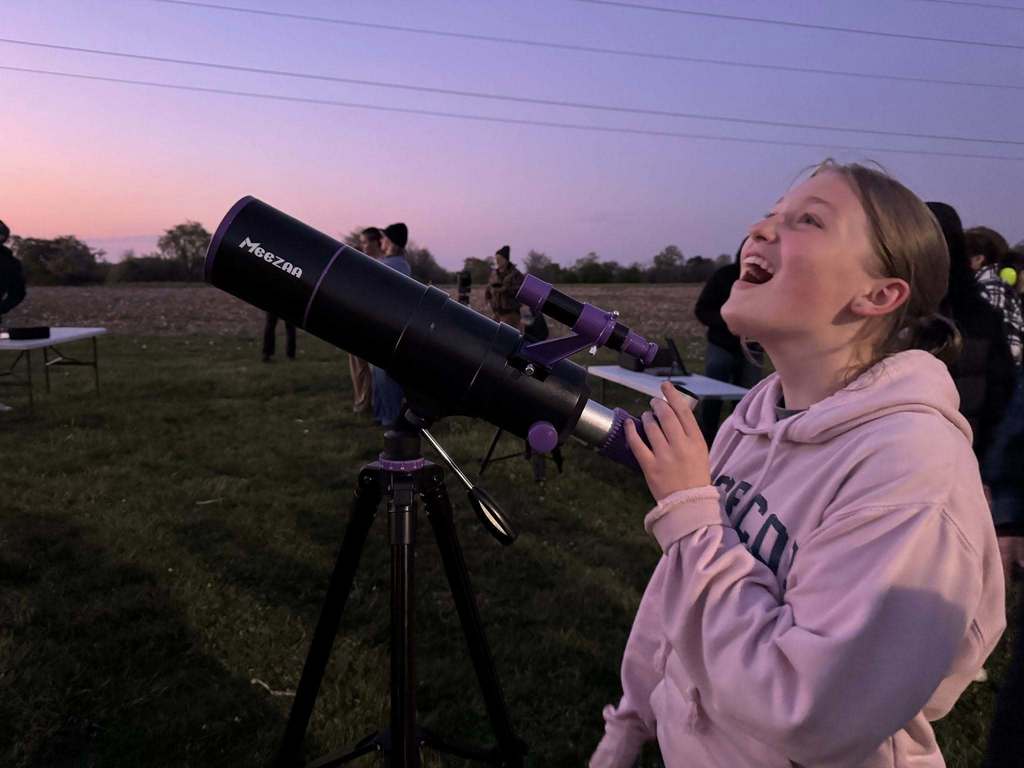 Student looking through a telescope