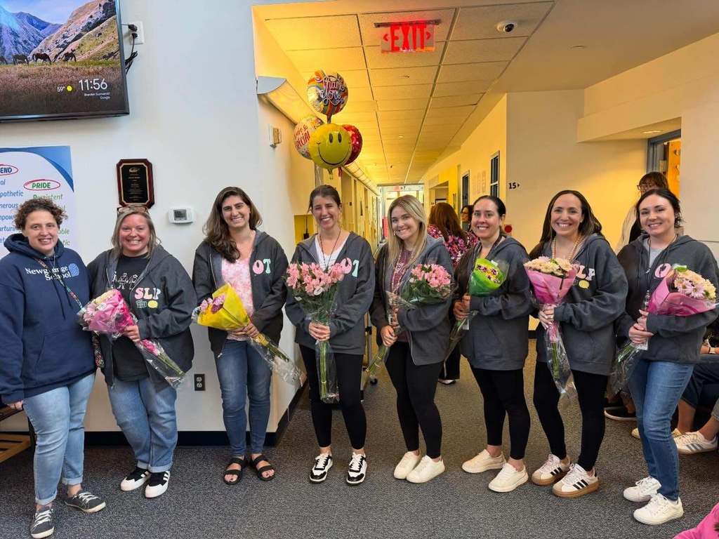 Teachers holding flower bouquets