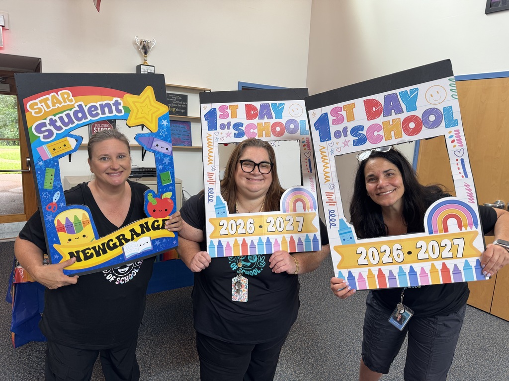 Three women in black shirts hold up photo-frame signs with the years 2026-2027. Each has a bright, colorful background.