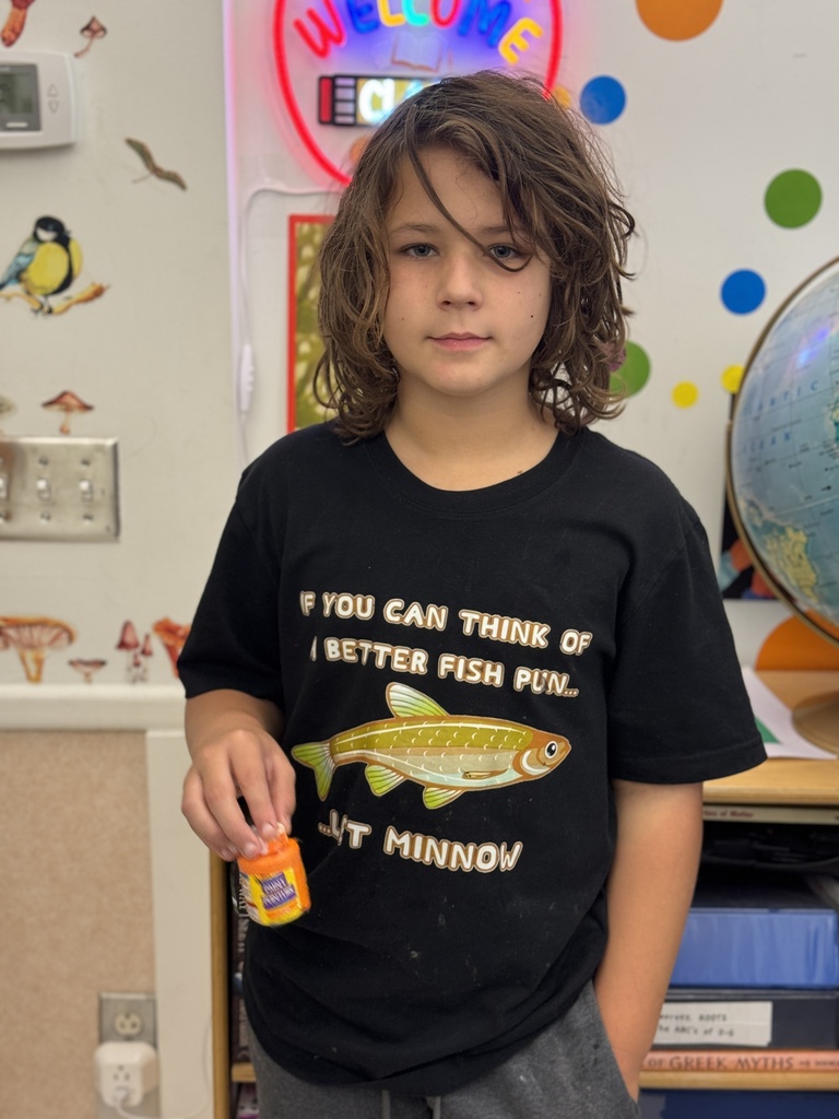 A child wearing a black T-shirt that says, "If you can think of a better fish pun...let minnow."