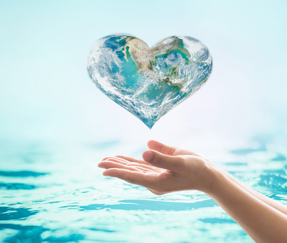 person holding a heart made of water
